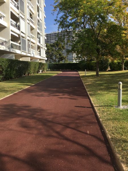 Goudronnage d'un chemin d'accès en enrobé rouge dans une copropriété